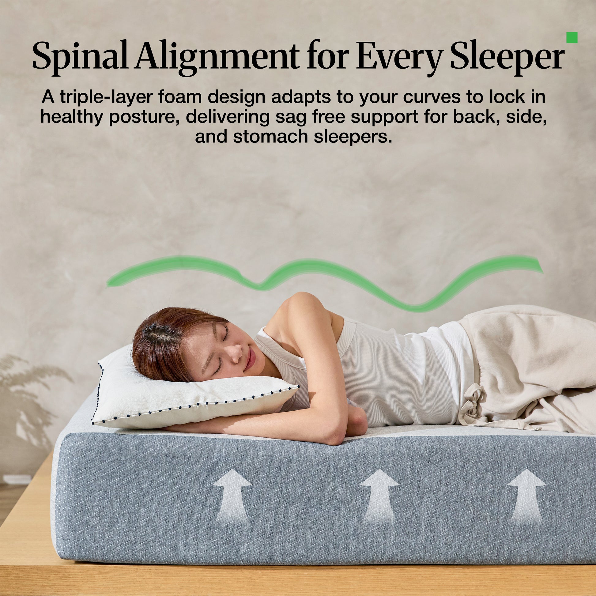 Woman lying on Lifement Basic Graphite Mattress showing spinal alignment support for back, side, and stomach sleepers with triple-layer foam design