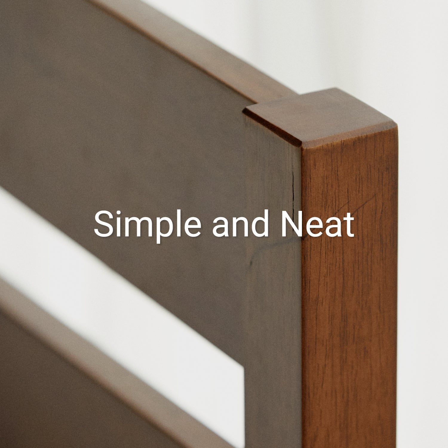 Corner of headboard on cherry colored wood bed frame